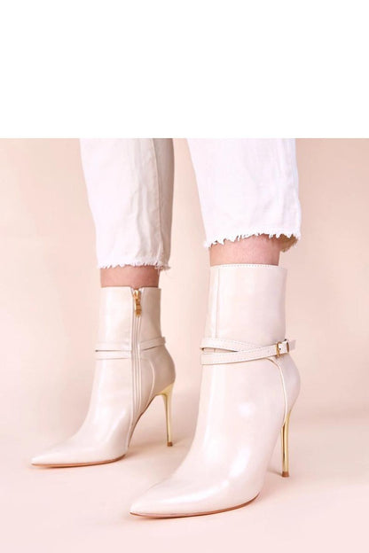 Elegant beige ankle boots with shiny gold stiletto heels by Solea, showcasing luxurious craftsmanship and sophisticated style, perfect addition to women's footwear collection.
