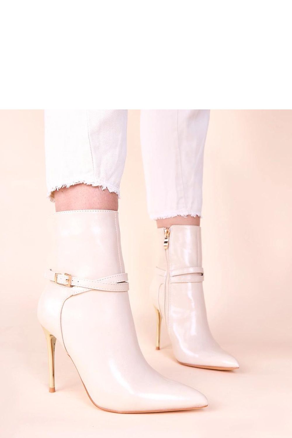 Stylish beige ankle boots showcasing a dazzling gold stiletto, embodying sophistication and chic design.