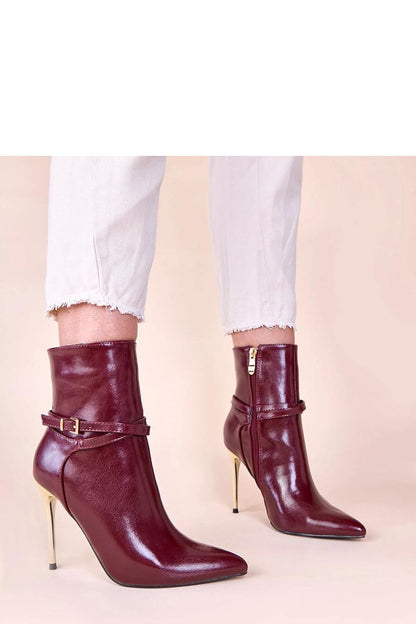 Elegant beige ankle boots with shiny gold stiletto heel, showcasing luxurious design and sophisticated craftsmanship.