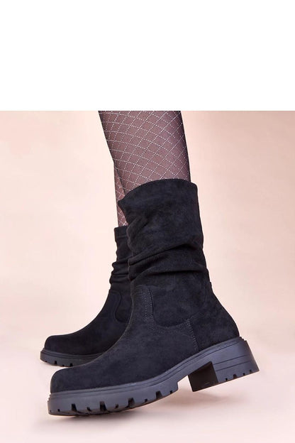 Close-up view of Solea's luxurious beige ruched platform boots, highlighting the fine craftsmanship and the unique texture of imitation leather suede.