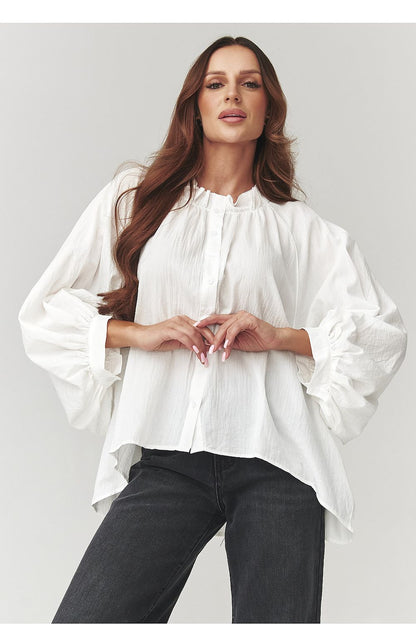 The chic silhouette of the Makadamia Women's Oversize Cotton Shirt, accentuating wide sleeves and classic collar for a sophisticated look.