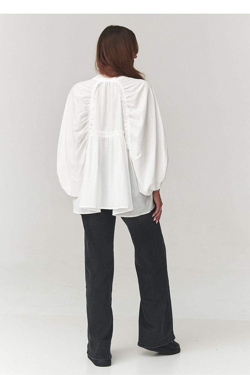 Close-up of Makadamia's women's oversize cotton shirt detailing front buttons and cuffs, emphasising its blend of modern design and classic elegance.