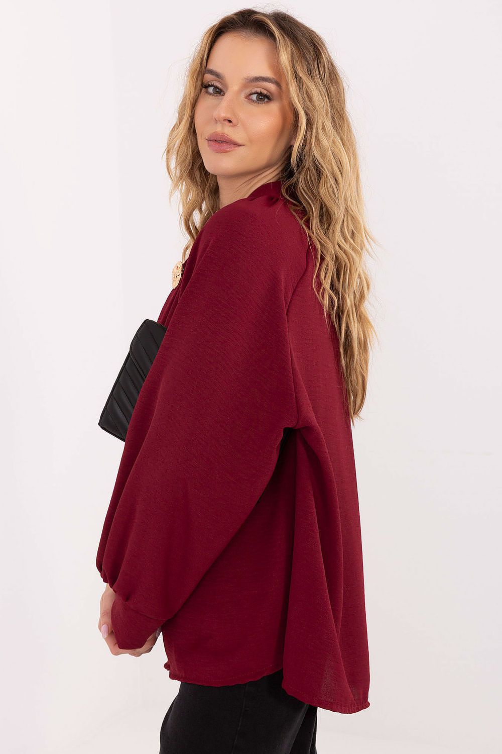 Stylish brooch adorns the Italy Moda blouse, adding a unique touch to the luxurious and elegant viscose fabric design.