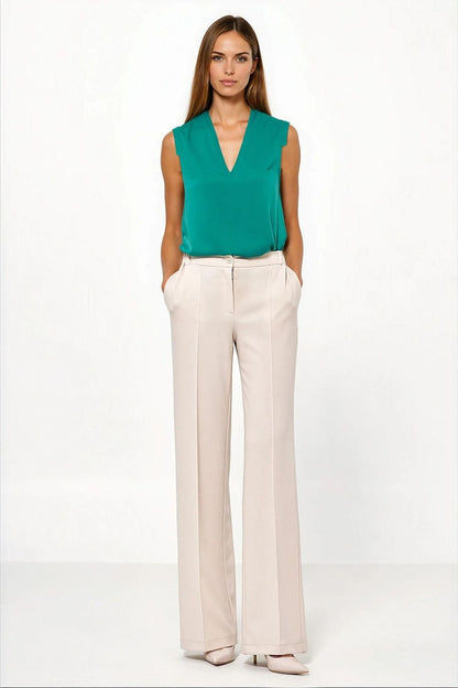 Close-up of luxurious fabric of caramel trousers for women by Nife, showcasing quality and softness.