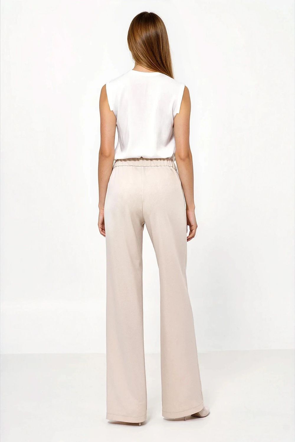 Stylish high-waisted caramel trousers for women by Nife paired with elegant blouse and heels.