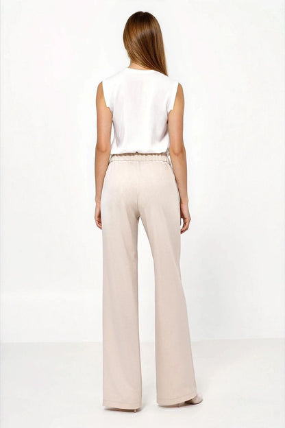 Stylish high-waisted caramel trousers for women by Nife paired with elegant blouse and heels.