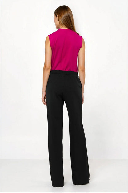 Close-up of the luxurious fabric of Nife's caramel loose cut trousers, showcasing the soft blend of polyester and spandex perfect for all-day comfort.