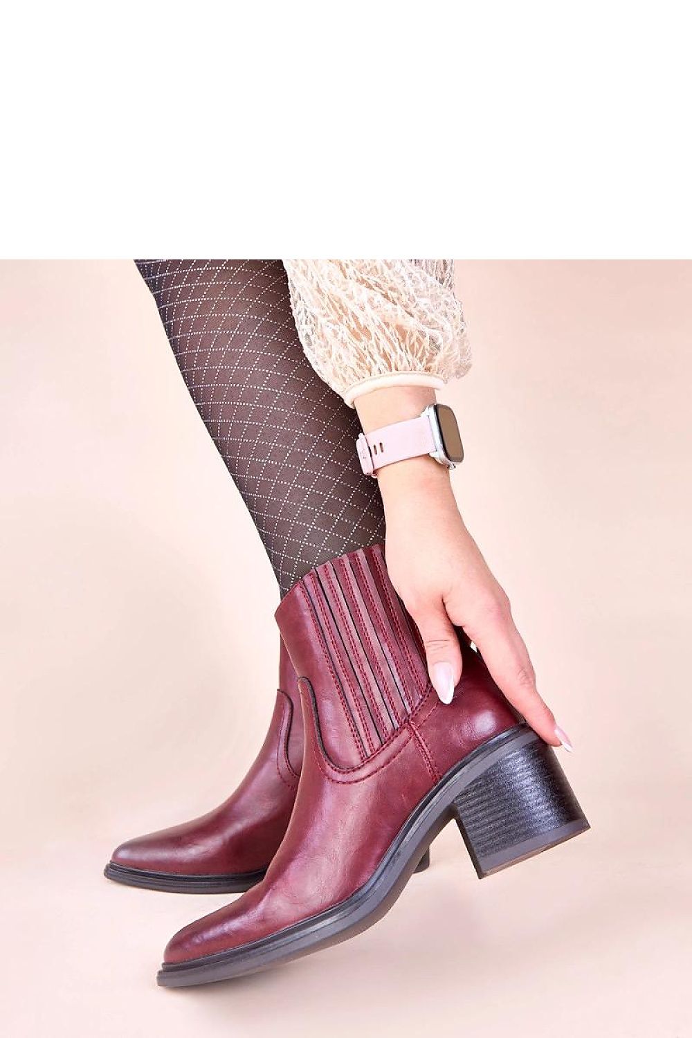 Fashionable styling of Solea's elegant burgundy ankle boots, perfect for transitioning from day to evening wear with their timeless design.