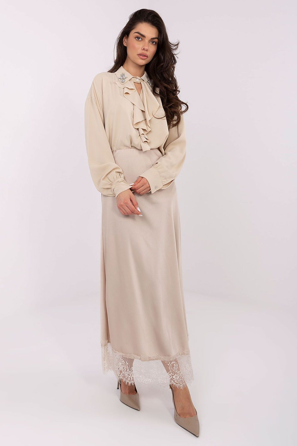 Elegant long-line polyester blouse by Factory Price displayed on a model, highlighting its flattering fit and feminine silhouette.