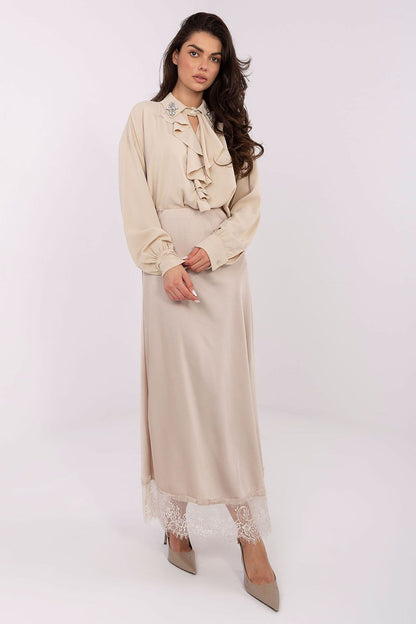 Elegant long-line polyester blouse by Factory Price displayed on a model, highlighting its flattering fit and feminine silhouette.