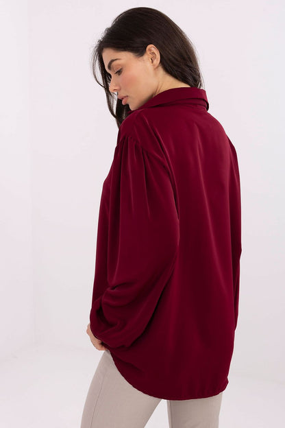 Elegant V-Neck Blouse by Factory Price featuring a detachable brooch, showcased on a model. The blouse has trendy puff sleeves and a lightweight polyester fabric, perfect for any stylish wardrobe.
