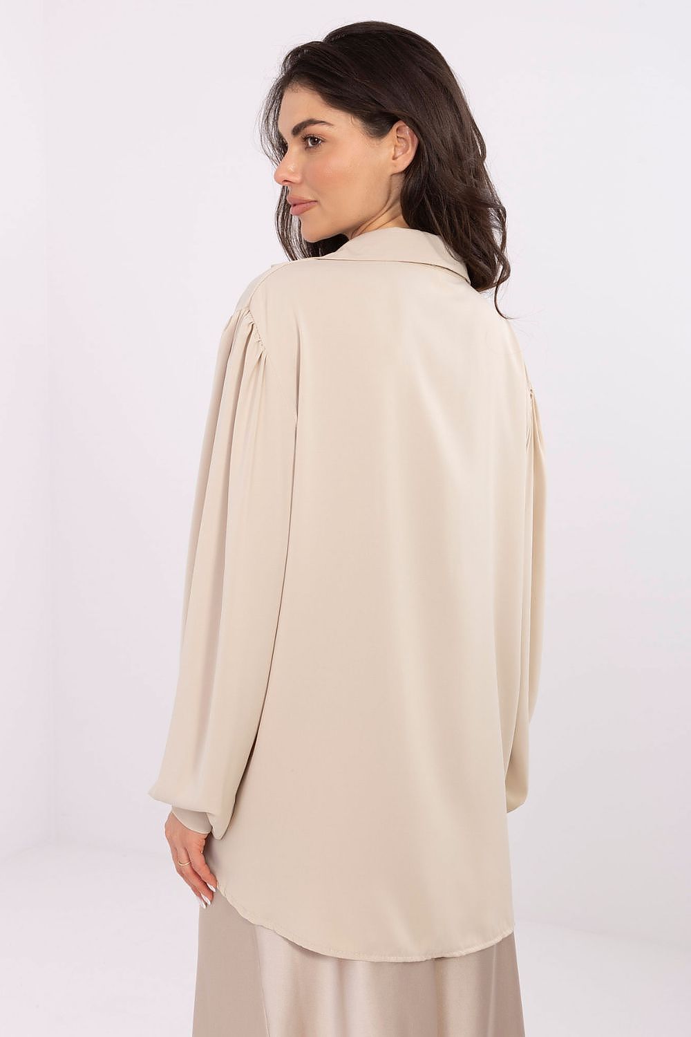 Side view of the Elegant V-Neck Blouse with trendy puff sleeves by Factory Price, highlighting its flattering silhouette and luxurious fabric.