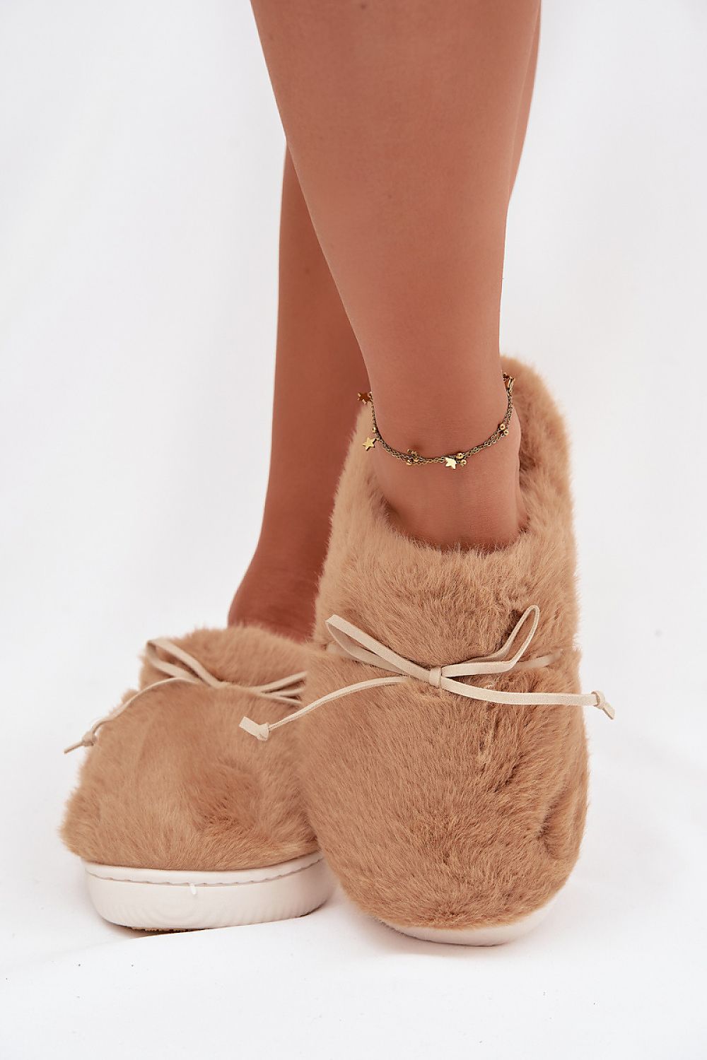 Luxury women's fur slippers with a charming bow by Step in style, embodying elegance and comfort for relaxing moments at home.