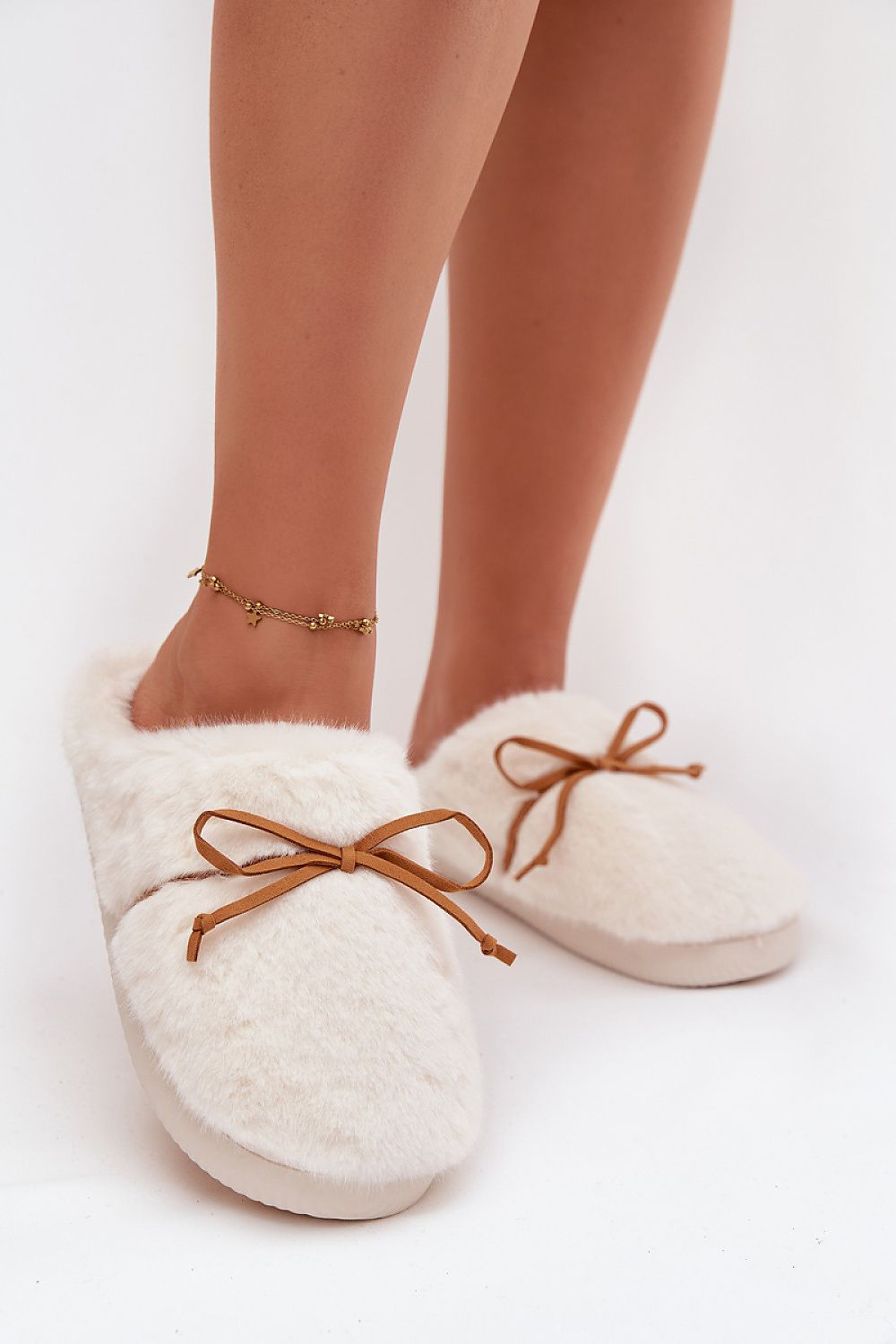 Step in Style's Luxury Fur Women's Slippers adorned with a charming bow, perfect for enhancing your loungewear while providing luxurious comfort.
