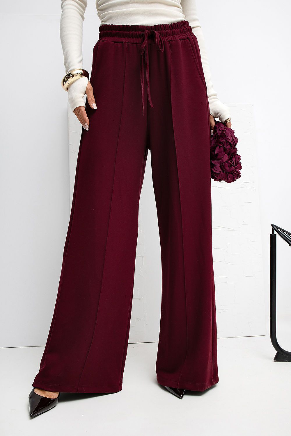 Rue Paris luxury palazzo sweatpants modelled in a chic outfit, demonstrating versatility in style for any occasion.