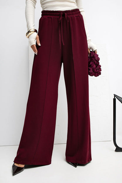 Rue Paris luxury palazzo sweatpants modelled in a chic outfit, demonstrating versatility in style for any occasion.