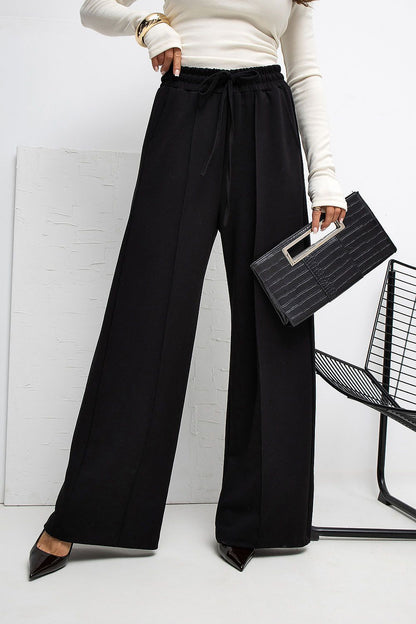 Side view of Rue Paris Luxury High-Waist Palazzo Sweatpants, displaying the comfortable tie waist and practical side slip pockets in a luxurious design.