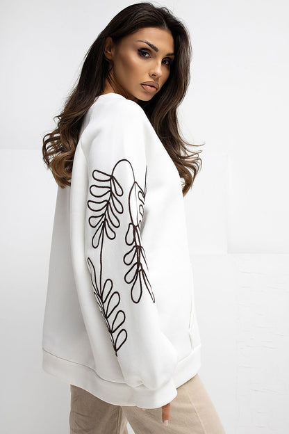 Close-up of exquisite embroidery on the sleeves of the Rue Paris Women's Casual Sweatshirt, showcasing elegant detailing on a soft cotton blend fabric.