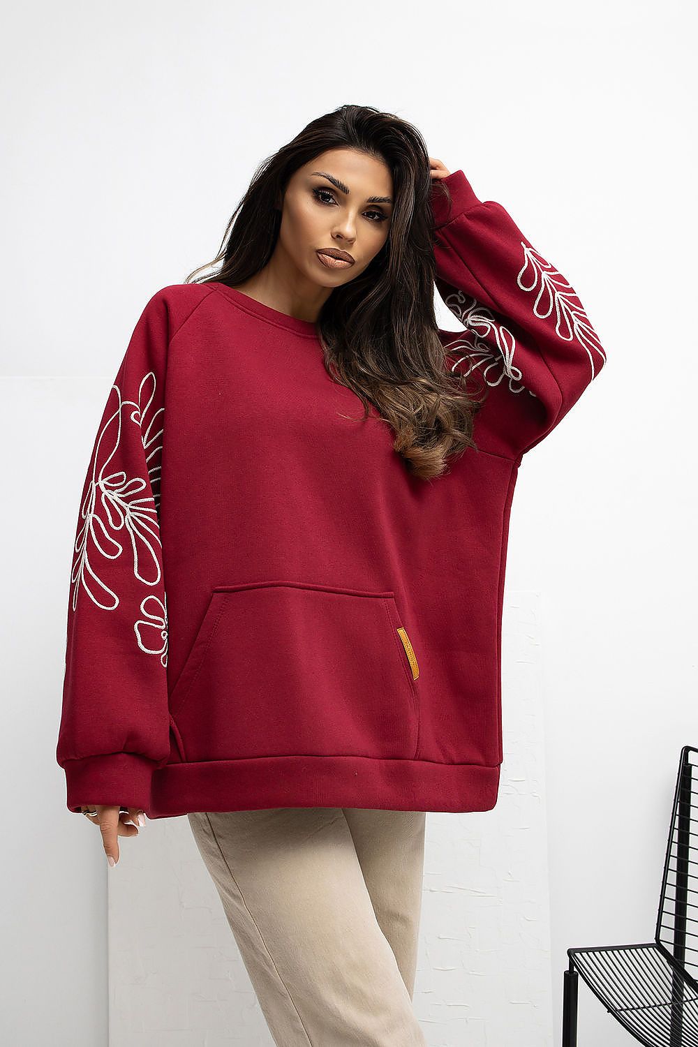 Model wearing Rue Paris Women's Embroidered Casual Sweatshirt with long puffy sleeves and a comfortable fit, perfect for elegant casual wear.