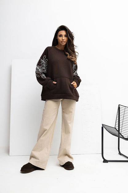 Chic Women's Embroidered Sweatshirt with kangaroo pocket by Rue Paris, designed for fashionable comfort and versatility in casual wear.