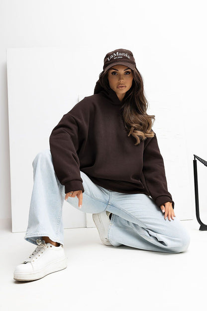 Close-up view of Rue Paris Casual Loose Hoodie Blouse, featuring charming patch detail and luxurious fabric texture.