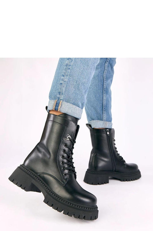 Stylish women's ankle boots in premium faux leather by Solea, featuring a round toe and convenient zipper closure for a luxurious look.