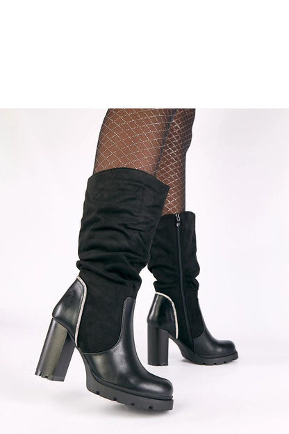 Stylish pairing of Solea Women's Elegant Eco Leather Heel Boots with a flowing dress, highlighting versatility for both formal and casual occasions.