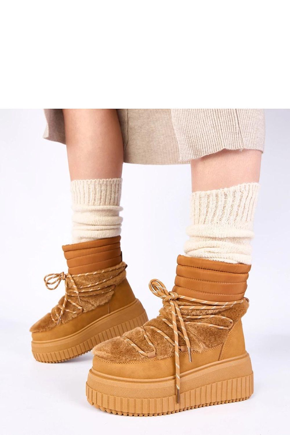 The Luxury Solea Laced Snow Boots With Fur displayed on a snowy background, exemplifying winter style while maintaining comfort and luxury.