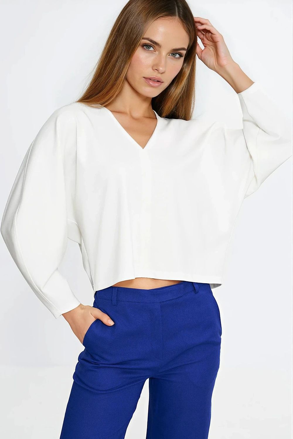 Nife Oversize V-Neck Blouse displayed on a mannequin, demonstrating the minimalist seam detail and sophisticated V-neckline.