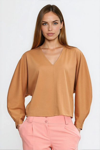 Close-up detailing of Nife oversized blouse showcasing the soft viscose fabric and unique v-neck design, offering refined comfort and style.
