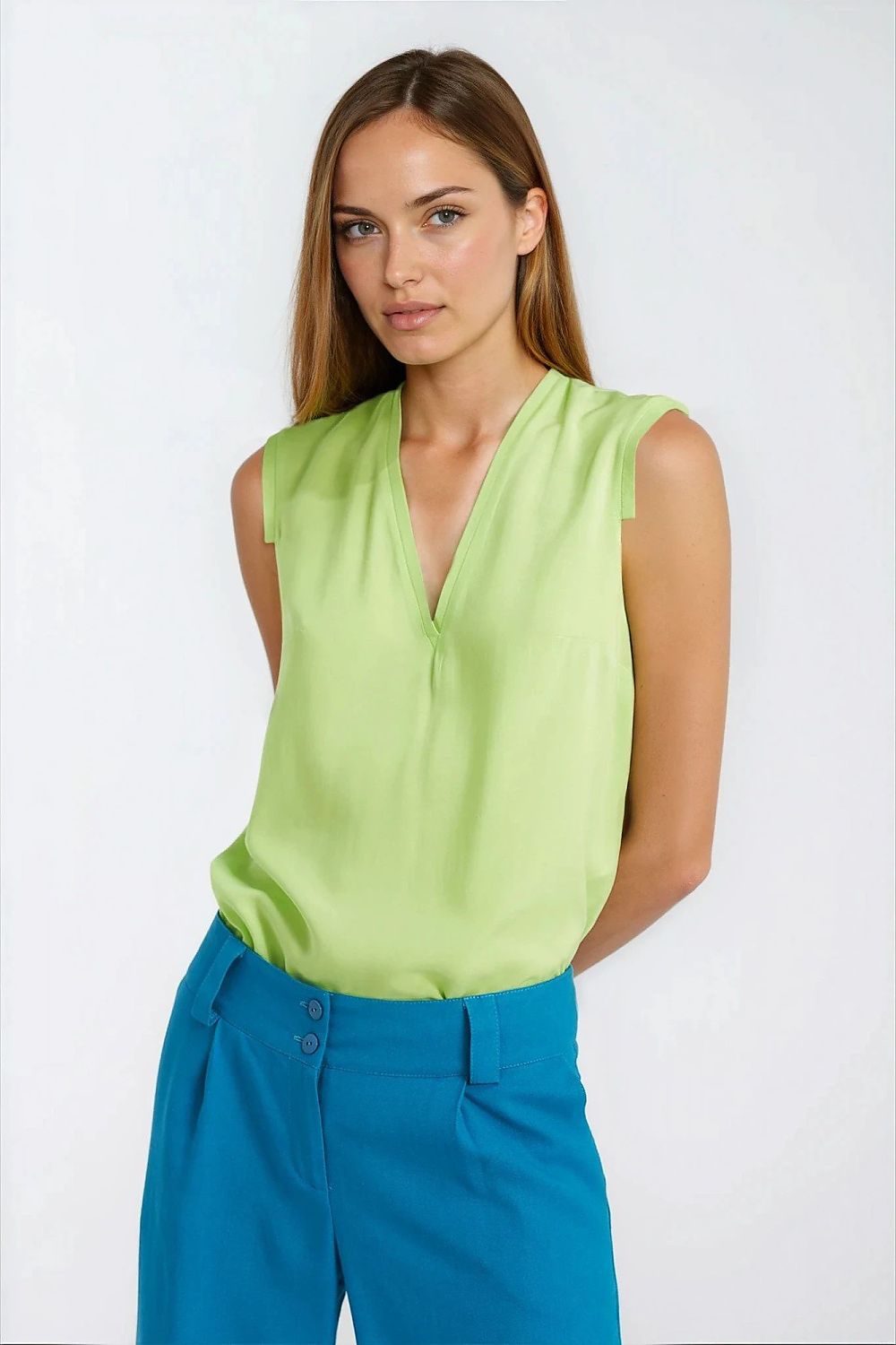 Model wearing the Elegant Lime Viscose Blouse by Nife, styled for a sophisticated casual look in vibrant cyber lime.