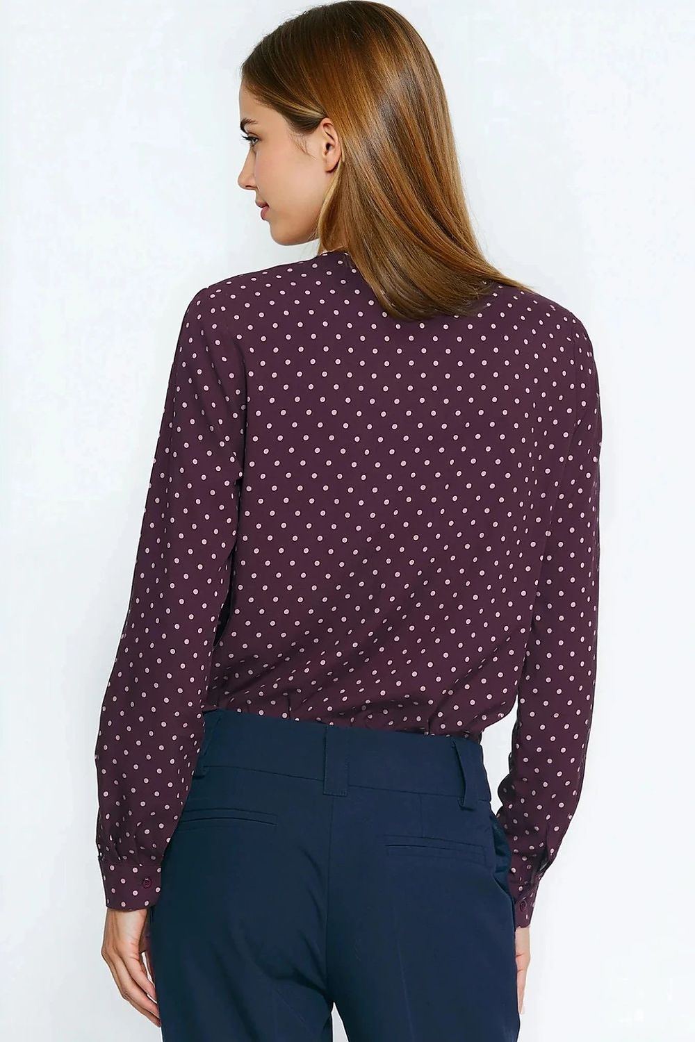 Model showcasing the stylish Silk Polka Dot Long Sleeve Shirt by Nife, paired with tailored trousers for an elegant fall look.