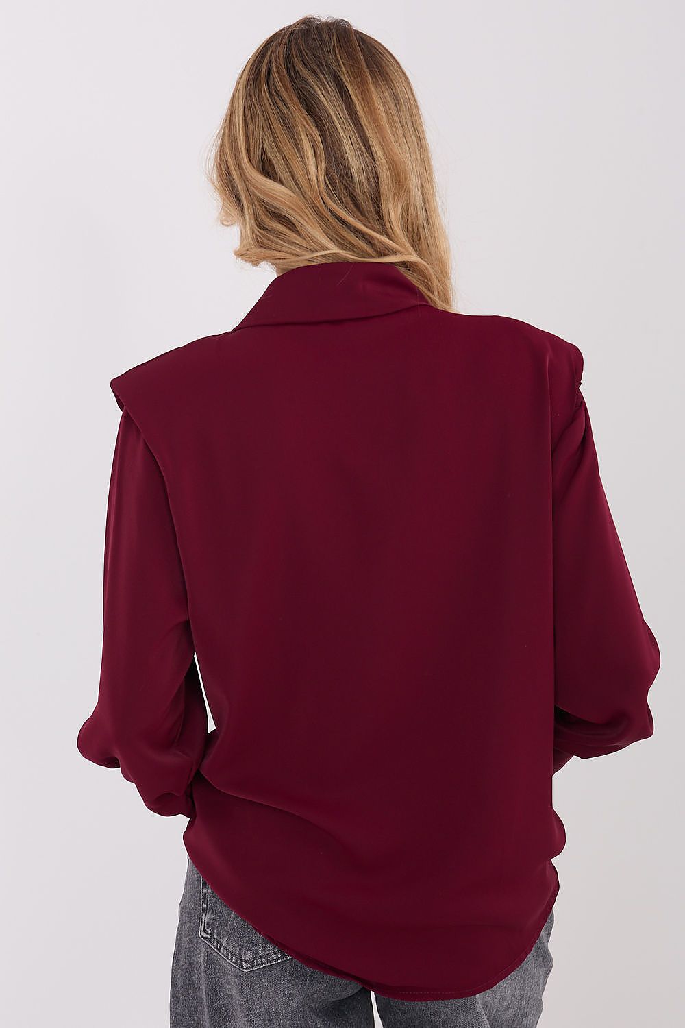 Model showcasing the Italy Moda elegant long sleeve shirt styled for a formal occasion, emphasizing versatility and feminine silhouette.