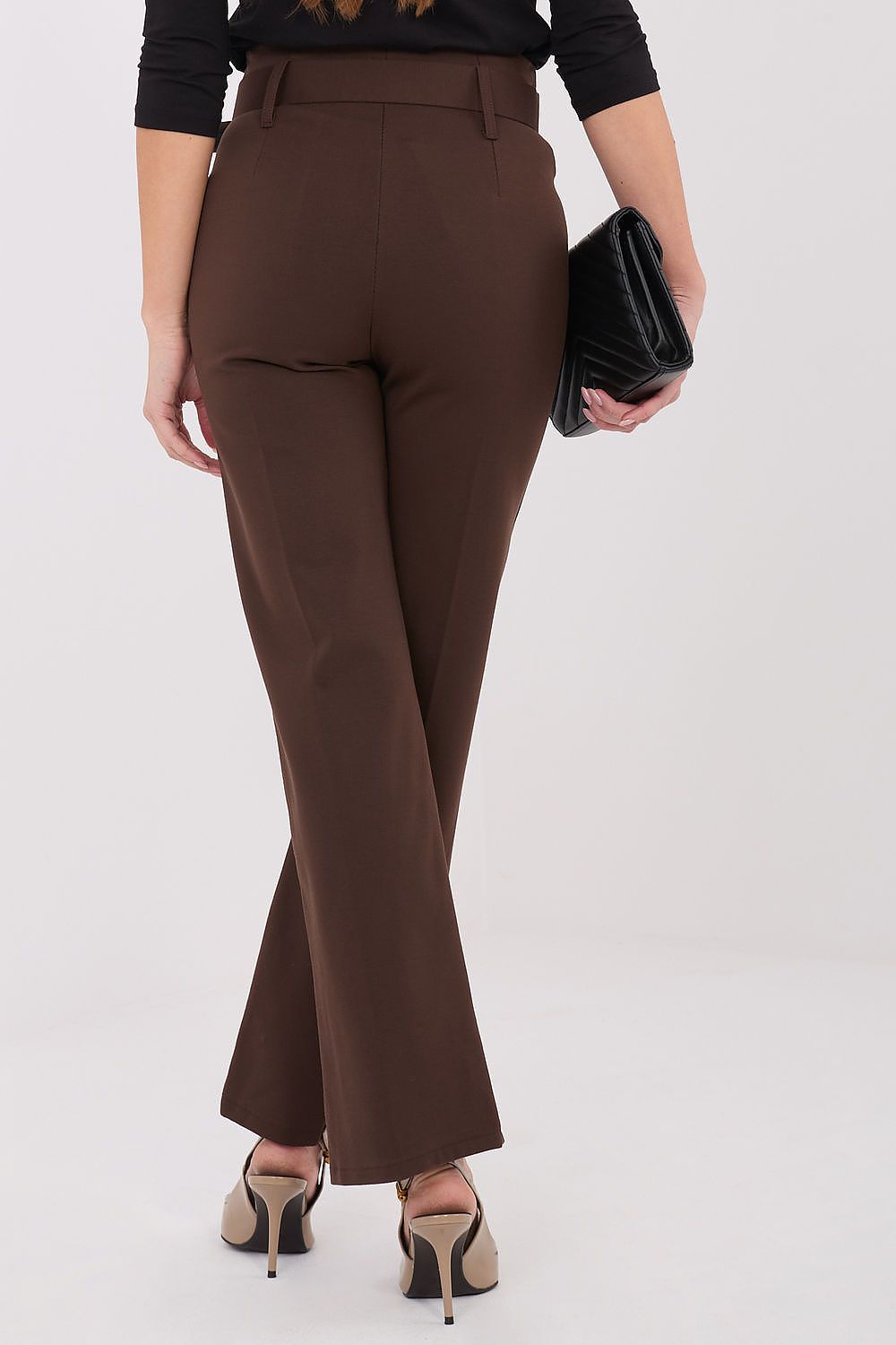 A model flaunting Italy Moda's flattering high waist trousers in various settings, emphasising versatility and style.