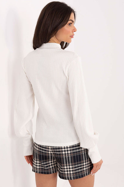 Model wearing Rue Paris elegant blouse with puff sleeves, perfect for casual and work settings.