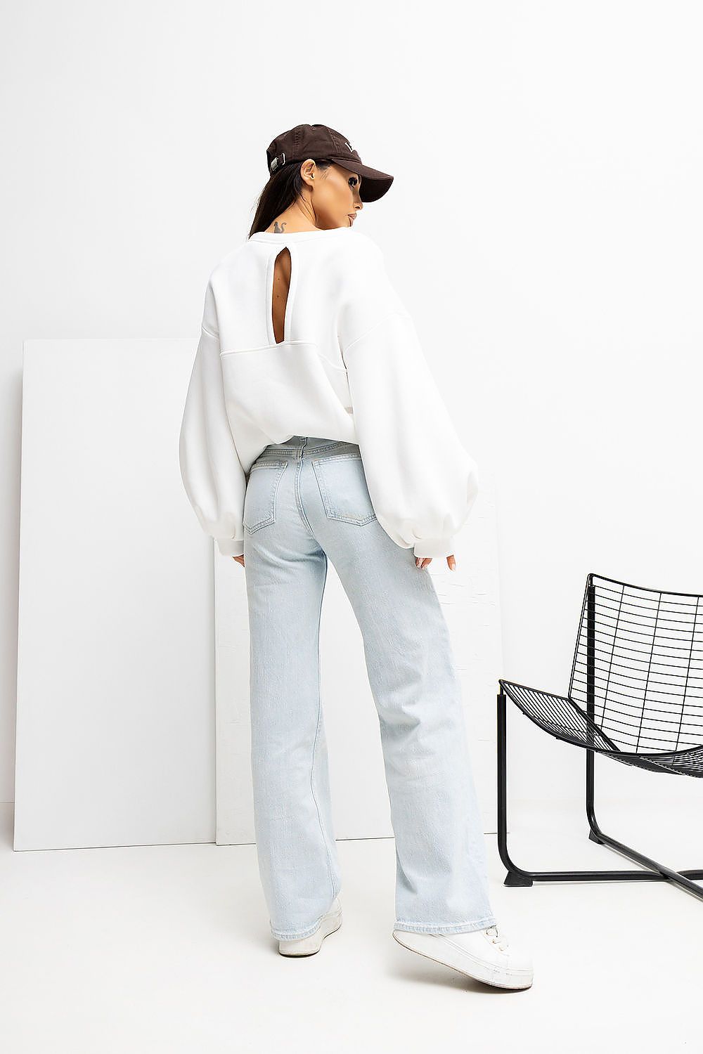 Back view of Rue Paris women's sweatshirt highlighting the unique vertical cut design and soft cotton blend, ideal for sophisticated everyday wear.