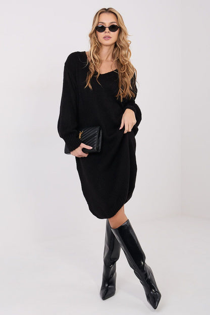 Stylish model wearing Factory Price Oversized Knit Midi Sweater Dress in a chic setting, demonstrating its versatility for both work and leisure.