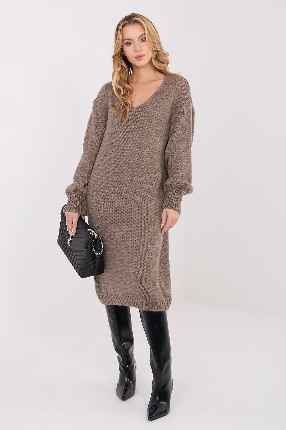 Minimalist oversized knit dress with feminine v-neck and long sleeves, exemplifying luxury casual wear from Factory Price.