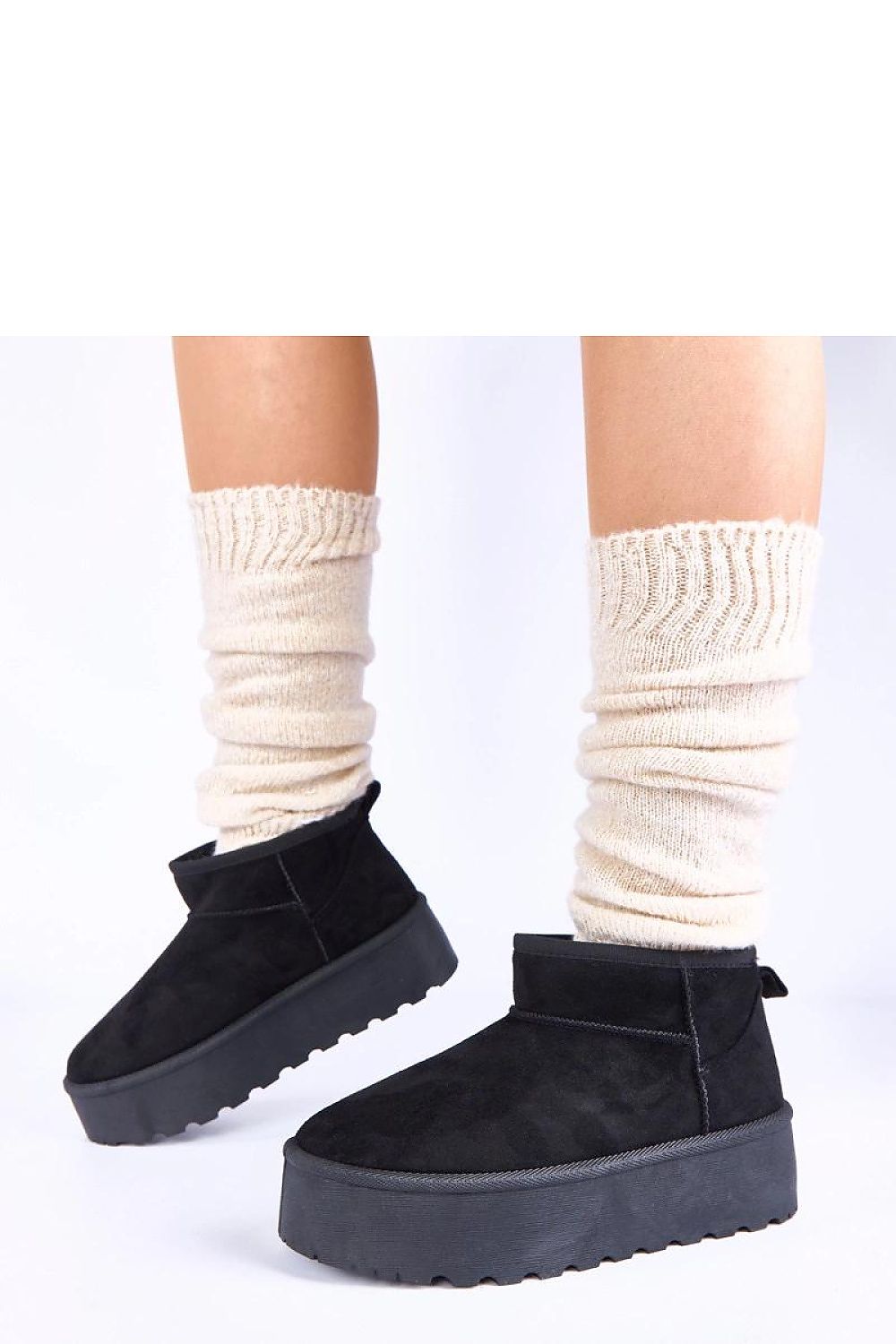 Close-up view of Gemre's Mouna black snow boots featuring a plush fur lining and a stable platform, blending fashion and function for cold weather.