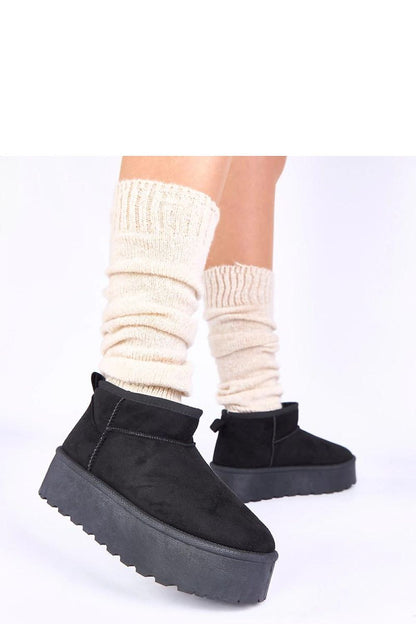 Sophisticated winter outfit styled with Gemre's Mouna black snow boots, illustrating their versatility and elegance for casual and urban settings.