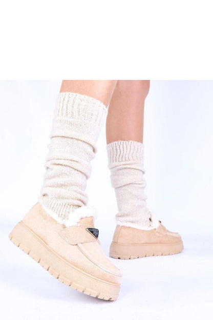 Side perspective of Solea's luxury women’s dark beige moccasins on the Kirby platform, illustrating the sleek design and practical insulation for chilly days.