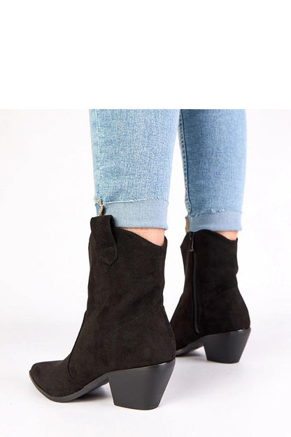 Gemre Women's Black Alka Post Cowboy Boots in a fashionable setting, highlighting their comfortable post heel and chic design for both casual and elegant wear.