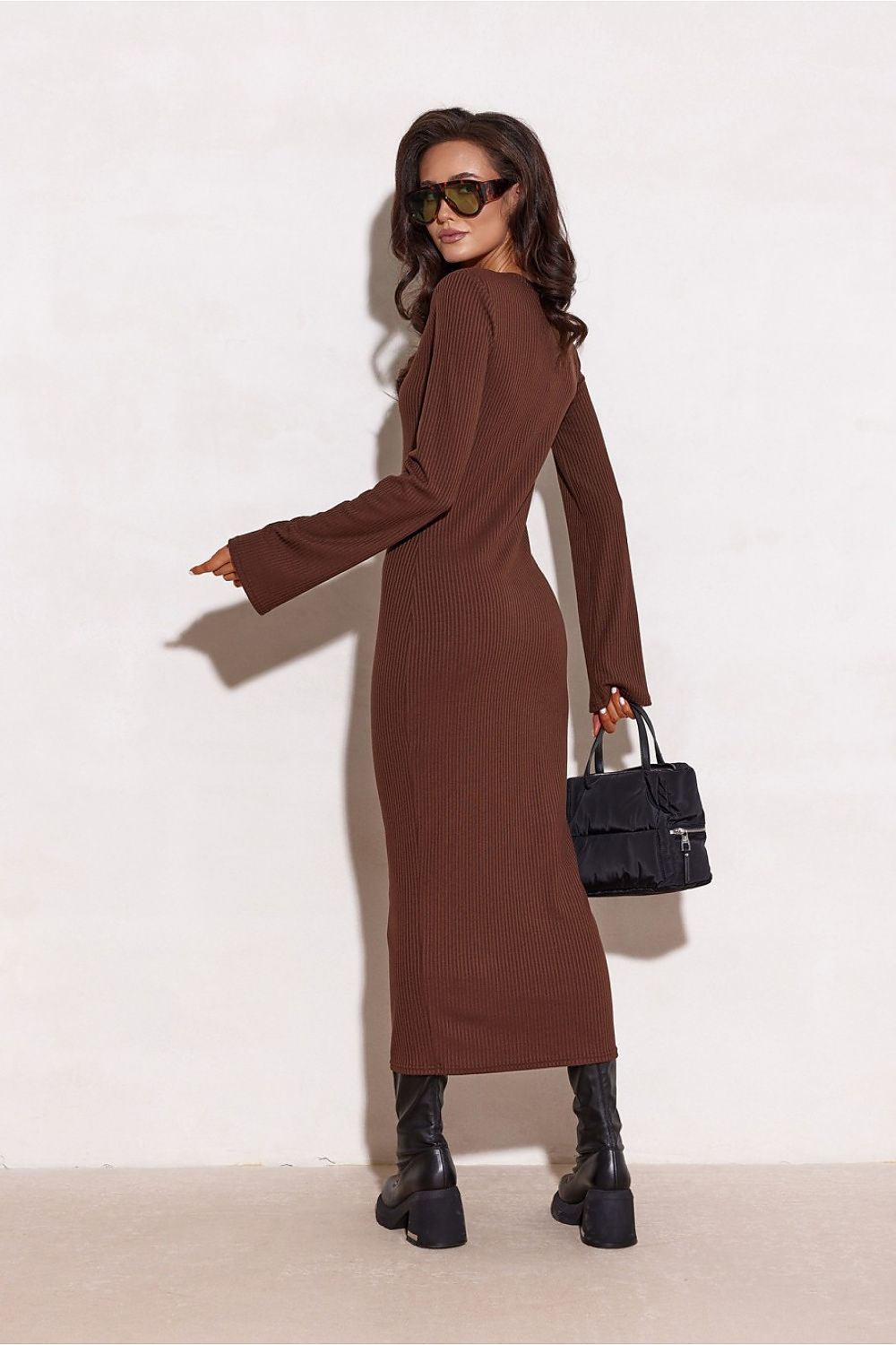 Roco Fashion's Elegant Knit Daydress hanging elegantly on a hanger, displaying its sophisticated design and flattering silhouette.