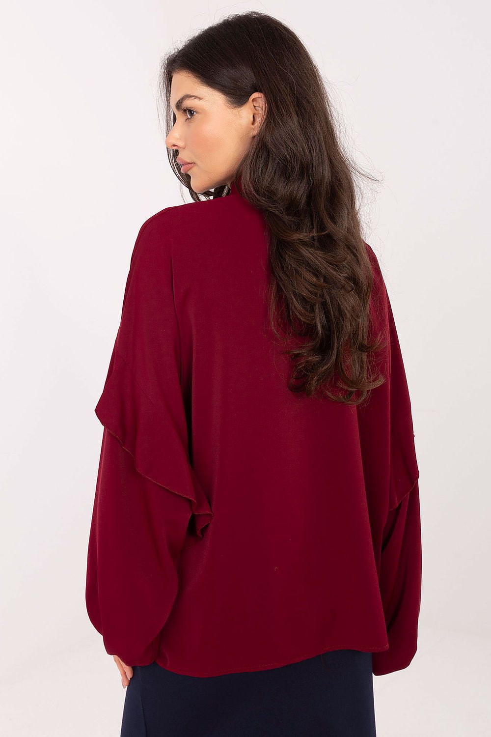 Close-up view of the luxurious ruffle detail on the collarless long sleeve woman's shirt by Factory Price, showcasing its soft polyester fabric and feminine charm.