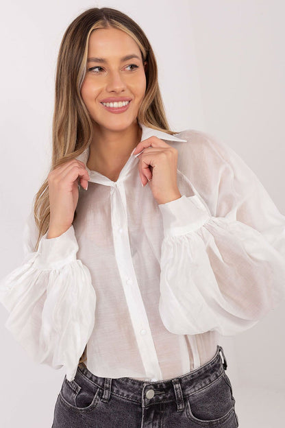 Close-up of elegant women's shirt's decorative buttons and puffy sleeves by Factory Price, emphasizing luxury and modern fashion in everyday wear.