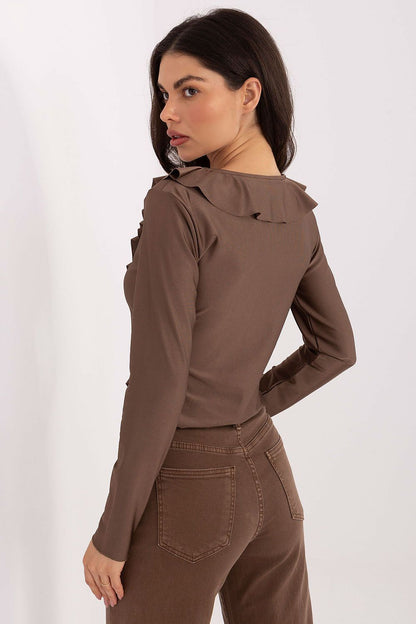 Elegant women's blouse by Italy Moda featuring long sleeves, a sophisticated neckline tie, and subtle ruffles for a modern and feminine silhouette.