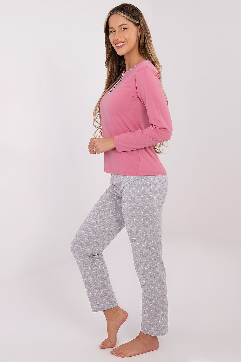 Relaxed model wearing Forever Pink luxury cotton women's pyjama set, showcasing the flattering fit and feminine design ideal for restful nights.