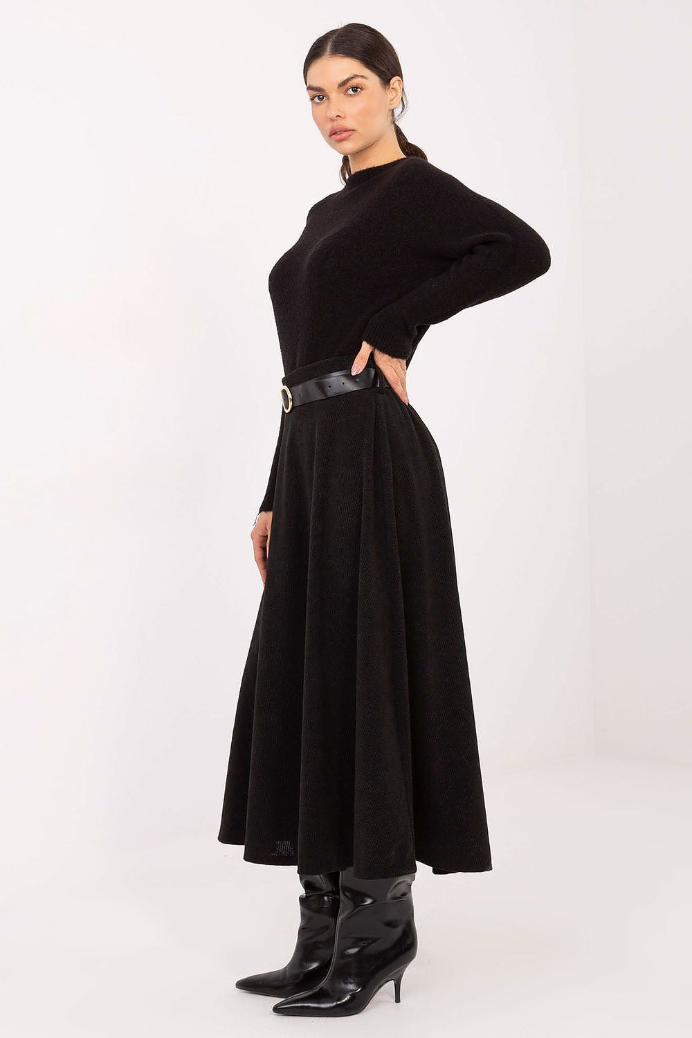 Sophisticated look of an elegant knitted midi skirt by Rue Paris, paired with a refined belt, ideal for formal events and work attire.