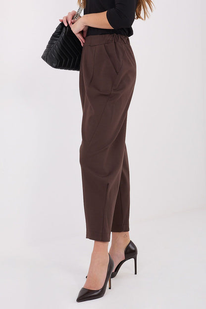 Side view of Rue Paris high-waisted trousers showcasing tapered legs and elastic waistband for a flattering silhouette.