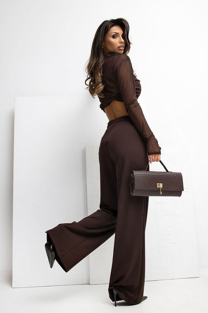 Lifestyle shot of a woman wearing Rue Paris Women's High Waist Wide Leg Tracksuit Trousers, styled for a chic and relaxed everyday look.